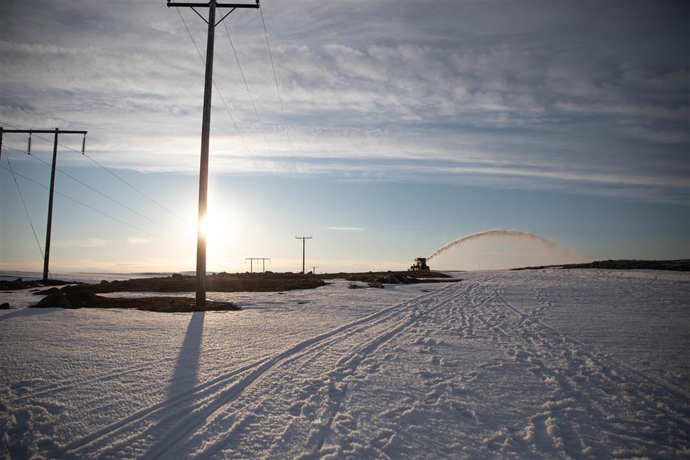 Snøfresing i arktisk vinterlandskap. Sola er lav, og våren er på vei. - Klikk for stort bilde